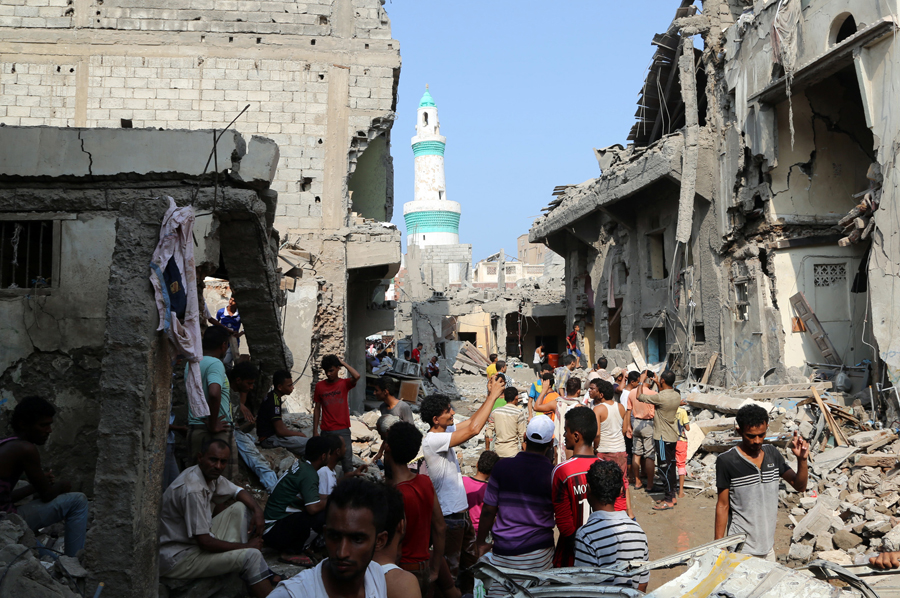 Yemenis gather on September 22 amid the rubble of buildings destroyed during Saudi-led air strikes on the rebel-held Yemeni port city of Hodeida the previous day. (Photo credit: String/AFP/Getty Images)