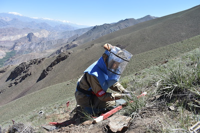 A member of Afghanistan's all-woman demining team clearing a mine in Bamyan province.