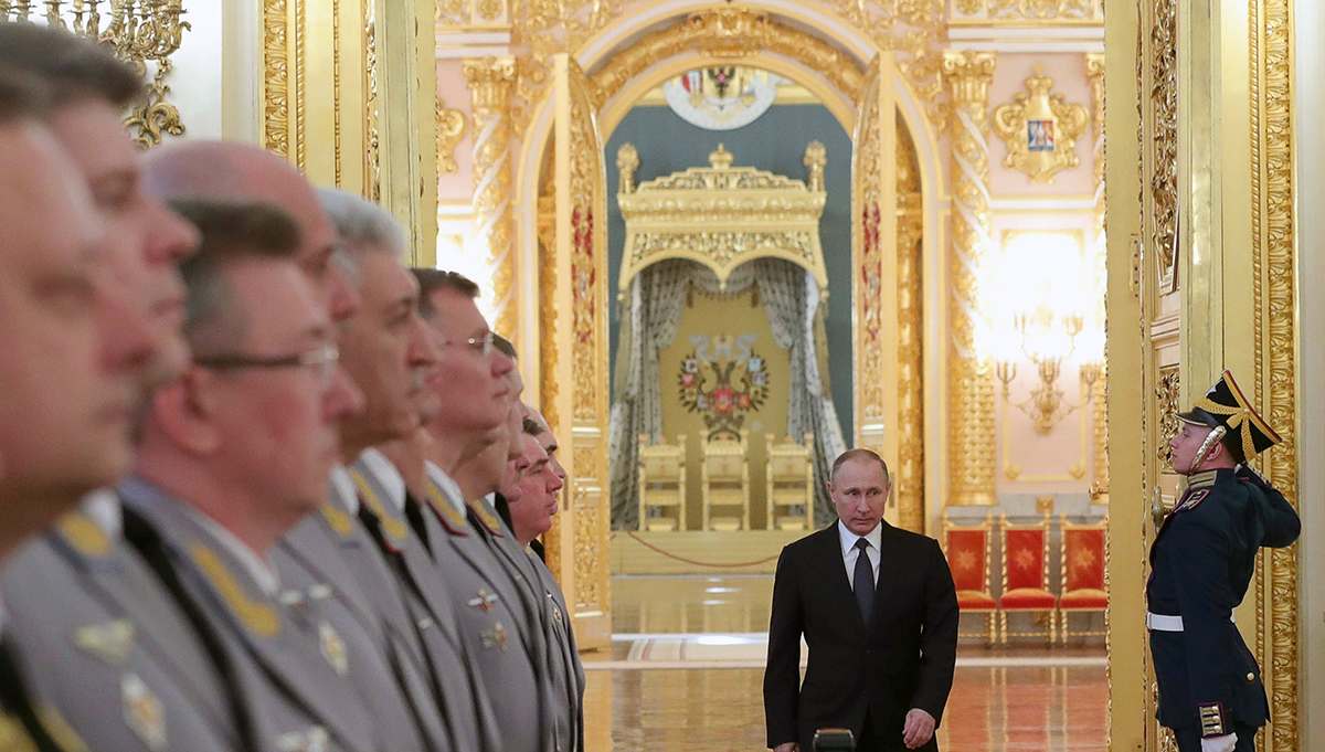 Russian President Vladimir Putin enters a hall in the Kremlin March 23 to meet with senior military officers promoted to higher positions. (Photo credit: Mikhail Klimentyev/AFP/Getty Images)