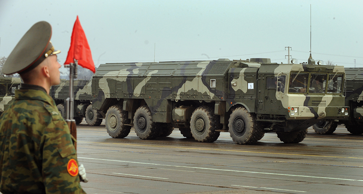 A Russian Iskander ballistic missile launcher rolls by a soldier during a parade rehearsal near Moscow on April 20, 2010. Recently, Russia reportedly has deployed Iskander-M missiles, which can carry conventional or nuclear warheads, to its western enclave of Kaliningrad, which borders NATO members Poland and Lithuania. (Photo credit: Alexander Nemenov/AFP/Getty Images)