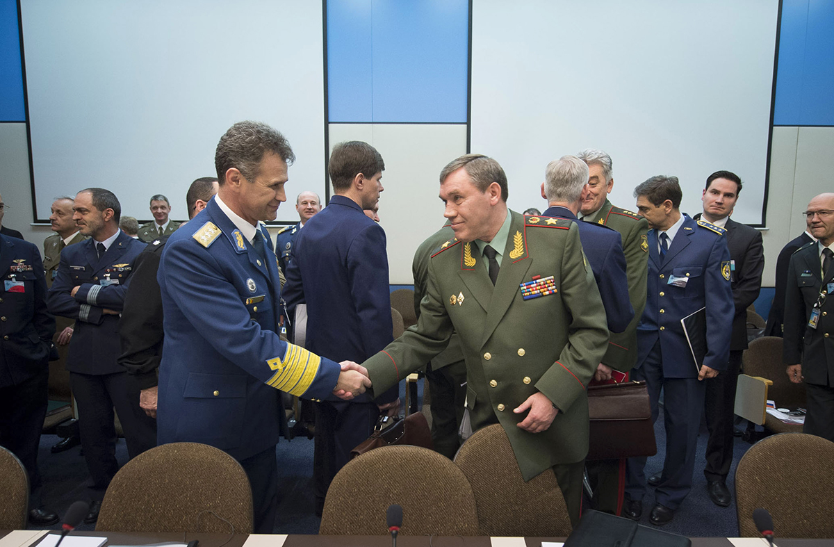 General Stefan Danila (left), chief of the Romanian Army General Staff, shakes hands with General Valery Gerasimov, chief of the General Staff of the Armed Forces of Russia and first deputy defense minister, at the NATO-Russia Council meeting of defense chiefs on January 22, 2014. Shortly thereafter, NATO suspended the council in response to Russia’s military actions against Ukraine. (Photo credit: NATO)