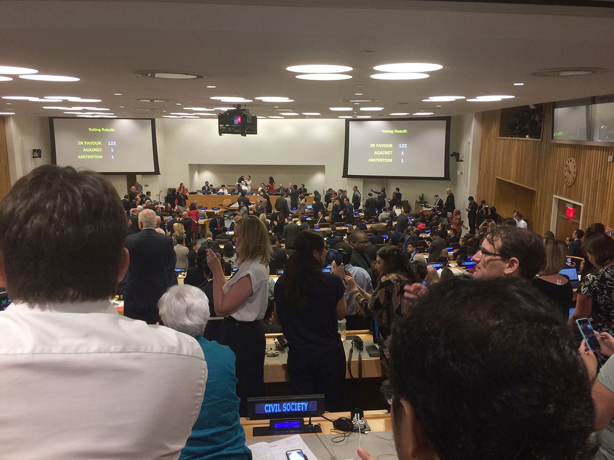 Delegates and observers applaud at the United Nations moments after the Treaty on the Prohibition of Nuclear Weapons is adopted July 7 by a vote 122 in favor, 1 against, and 1 abstention.  (Photo credit: Alicia Sanders-Zakre/Arms Control Association)
