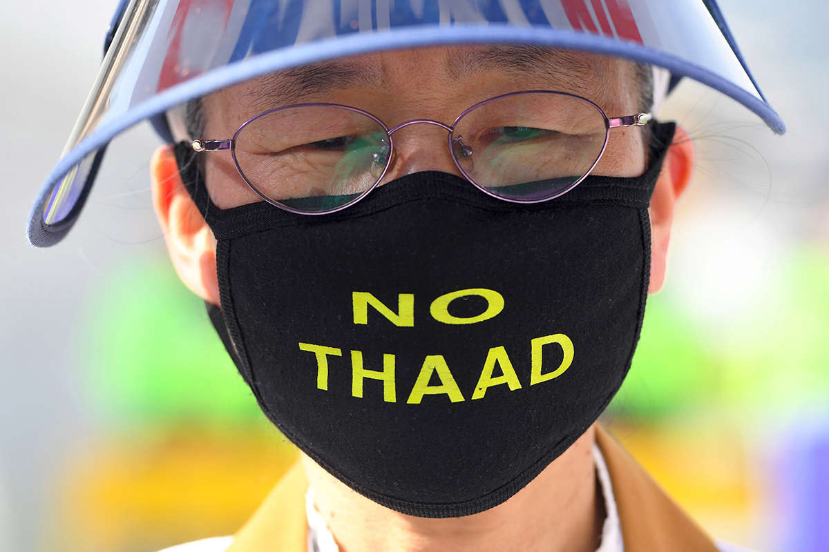 A South Korean protester wears a ‘No THAAD’ face mask during an April 28 rally in Seoul against the deployment of the U.S. Terminal High Altitude Area Defense (THAAD) system. (Photo credit: Jung Yeon-Je/AFP/Getty Images)