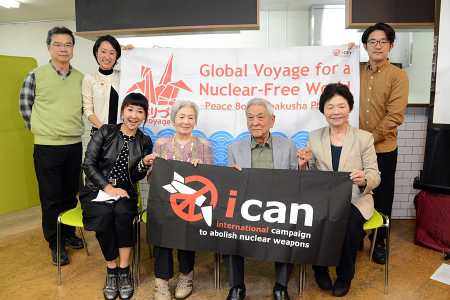 Three survivors of the U.S. atomic bombs dropped on Hiroshima and Nagasaki in 1945 pose with their supporters October 6 in Tokyo to congratulate ICAN on being awarded the 2017 Nobel Peace Prize. Fihn has said the award also honors the elderly hibakusha, who embody the humanitarian aspects of the campaign.  (Photo credit: STR/AFP/Getty Images)