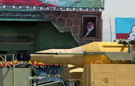 A military truck carries a Qadr medium-range ballistic missile past a portrait of Iranian Supreme Leader Ayatollah Ali Khamenei during a military parade in Tehran September 22, 2015. One version of that missile has a range of up to 2,000 kilometers, according to Iran’s Islamic Revolutionary Guard Corps.  (Photo credit: ATTA KENARE/AFP/Getty Images)