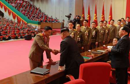 This December 12, 2017 photo from North Korea's official Korean Central News Agency shows North Korean leader Kim Jong Un in Pyongyang presenting awards to scientists for their successful work on the Hwasong-15 intercontinental-range ballistic missile. (Photo: AFP/Getty Images)