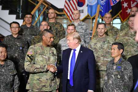 President Donald Trump shakes hands with General Vincent Brooks, commander of U.S. Forces Korea, at the 8th Army Operational Command Center at Camp Humphreys, south of Seoul, on November 7, 2017. The Nuclear Posture Review makes no mention of the role diplomacy could play in addressing the North Korean nuclear threat. (Photo: JIM WATSON/AFP/Getty Images)
