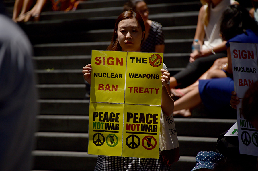 An anti-nuclear protester holds a placard at a February 5 rally in Sydney, Australia. Supporters of the International Campaign to Abolish Nuclear Weapons (ICAN) and Japan’s Peace Boat group gathered to urge the Australian and Japanese governments, both United States defense allies, to sign the Treaty on the Prohibition of Nuclear Weapons. (Photo: Peter Parks/AFP/Getty Images)