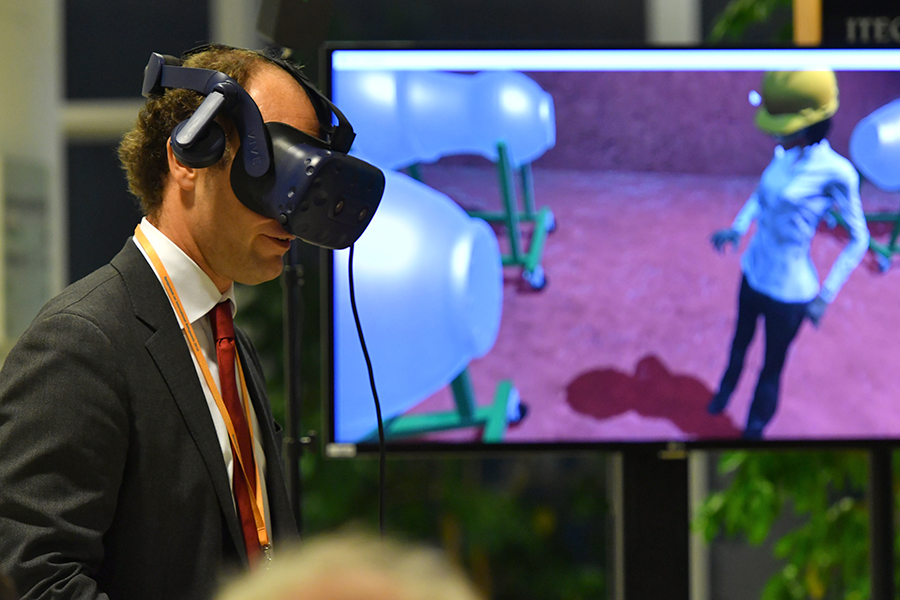 Participants at the International Atomic Energy Agency’s safeguards symposium watch a virtual-reality demonstration on November 5 in Vienna. (Photo: Dean Calma/IAEA)