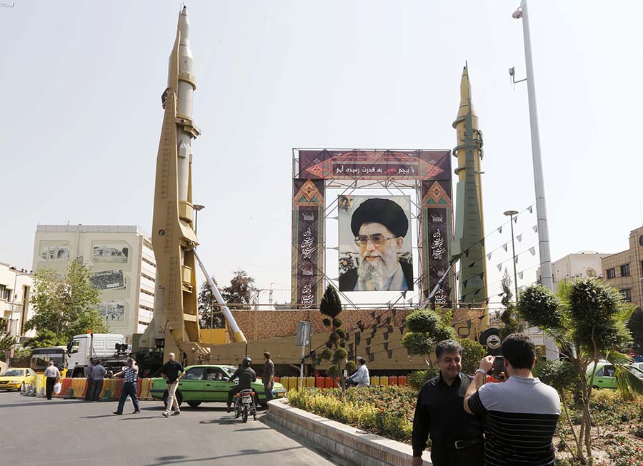 Iranian Sejjil (left) and Ghadr-H medium-range ballistic missiles are displayed in Tehran September 25, 2017 next to a portrait of Supreme Leader Ayatollah Ali Khamenei during annual defense-week events. (Photo: Atta Kenare/AFP/Getty Images)