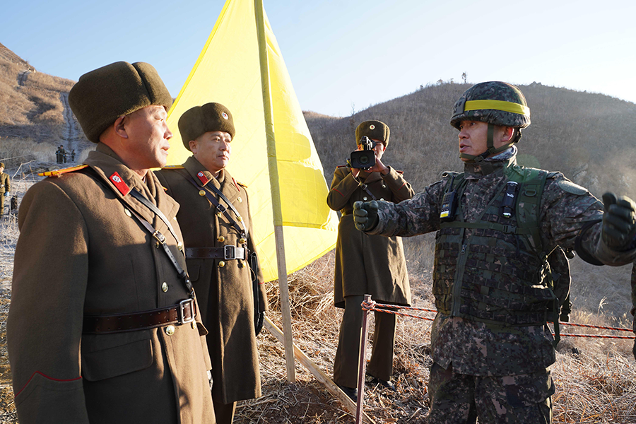 In an image provided by South Korean Defense Ministry, North Korean soldiers (left) talk with a South Korean soldier during mutual on-site verification of the withdrawal of guard posts along the Demilitarized Zone on December 12, 2018. The two Koreas have begun to destroy 20 guard posts along their heavily-fortified border under an agreement reached during the September 2018 Pyongyang summit between South Korean President Moon Jae-in and North Korean leader Kim Jong Un.  (Photo: South Korean Defense Ministry via Getty Images)