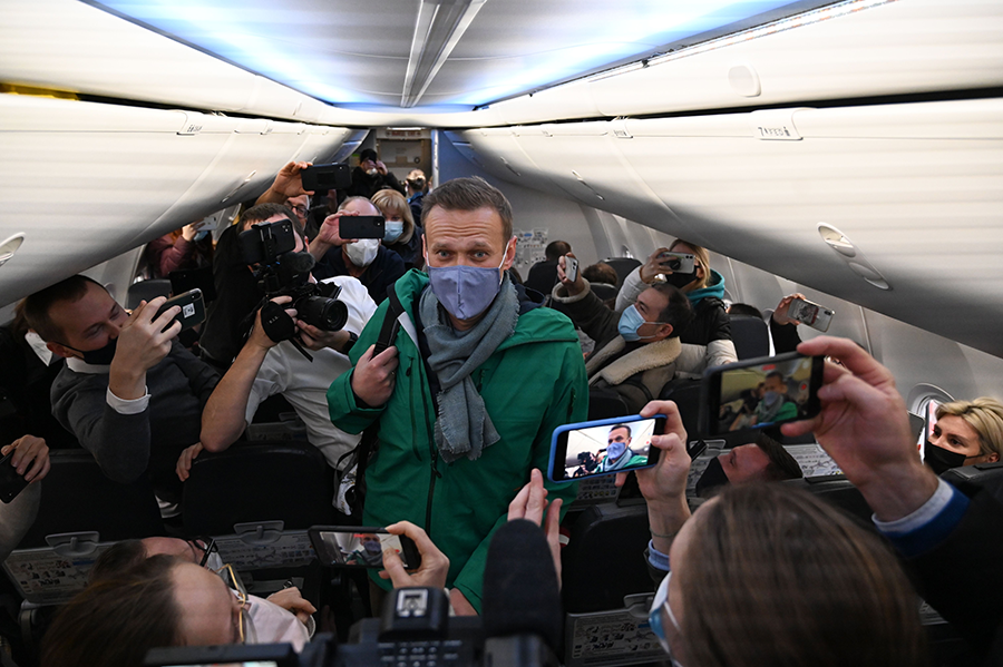 Russian opposition leader Alexei Navalny walks to his airplane seat on a January 2021 trip to Moscow from Berlin, where he was treated for a poisoning attack that he said was carried out under orders of Russian President Vladimir Putin. Navalny was arrested upon arrival in the Russian capital and remains imprisoned. His case has exacerbated concerns about the eroding global norm against chemical weapons use. (Photo by Kirill Kudryavtsev/AFP via Getty Images)