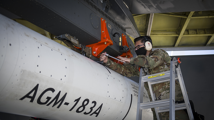A U.S. airman with the 912th Aircraft Maintenance Squadron secures the AGM-183A Air-launched Rapid Response Weapon (AARW) as it is loaded under the wing of a B-52H Stratofortress bomber at Edwards Air Force Base, California in 2020. (Photo by U.S. Air Force)