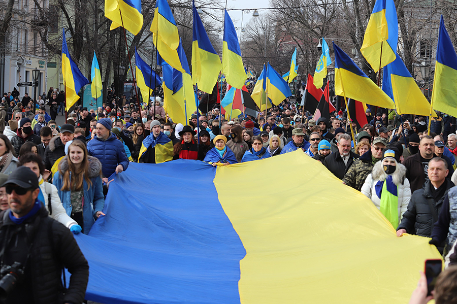 Protesters carry a giant Ukrainian flag during a rally in Odessa on February 20 to show unity and support of Ukrainian integrity amid soaring tensions with Russia. (Photo by Oleksandr Gimanov/AFP via Getty Images))