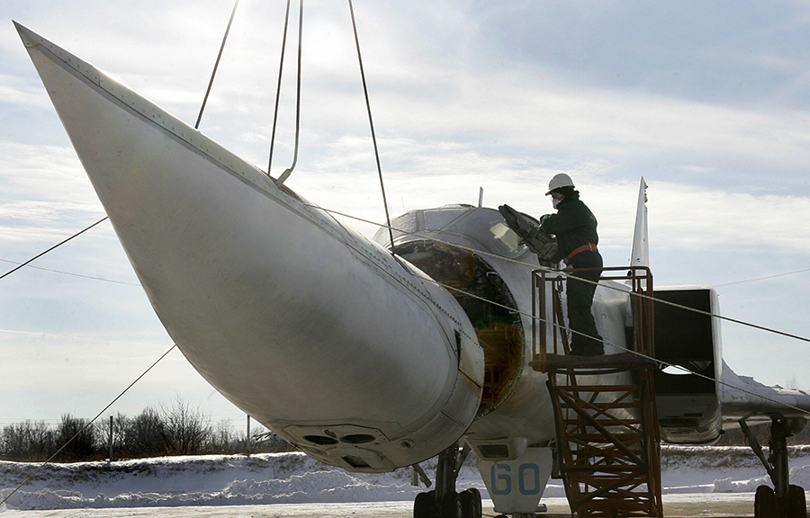A worker on a Ukrainian military base in 2006 cuts the nose off the last of Ukraine's Tupolev-22M3 bombers, also known as the 