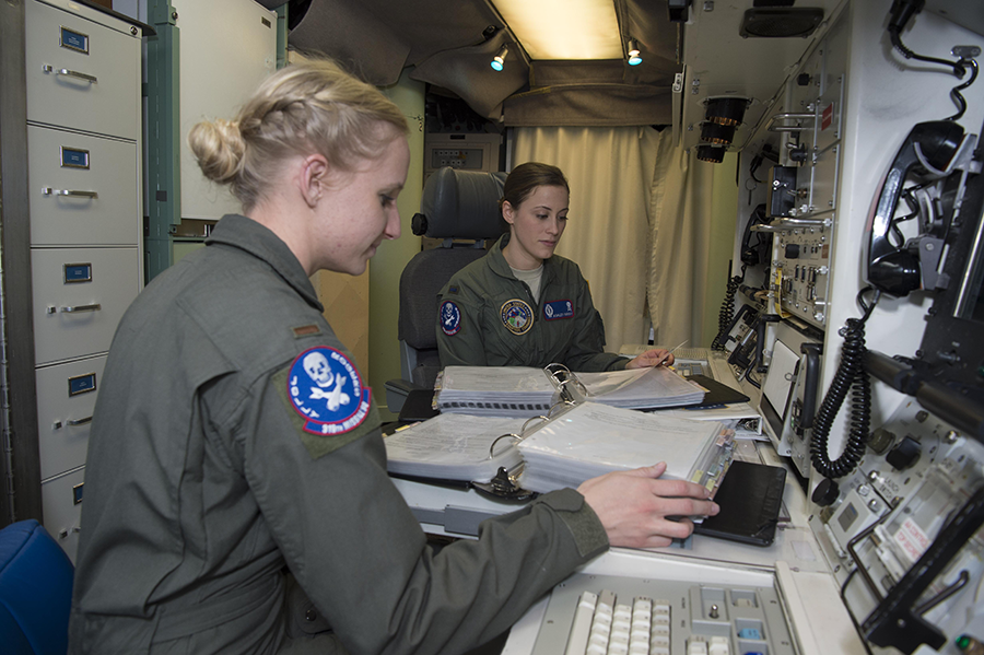 First Lt. Ashley Mirsky, 319th Missile Squadron missile combat crew commander (L), and 2nd Lt. Marie Blair, 319th MS deputy missile combat crew commander, in 2016 run through a checklist in a launch control center at F.E. Warren Air Force Base, Wyo. (U.S. Air Force photo by 1st Lt. Veronica Perez)