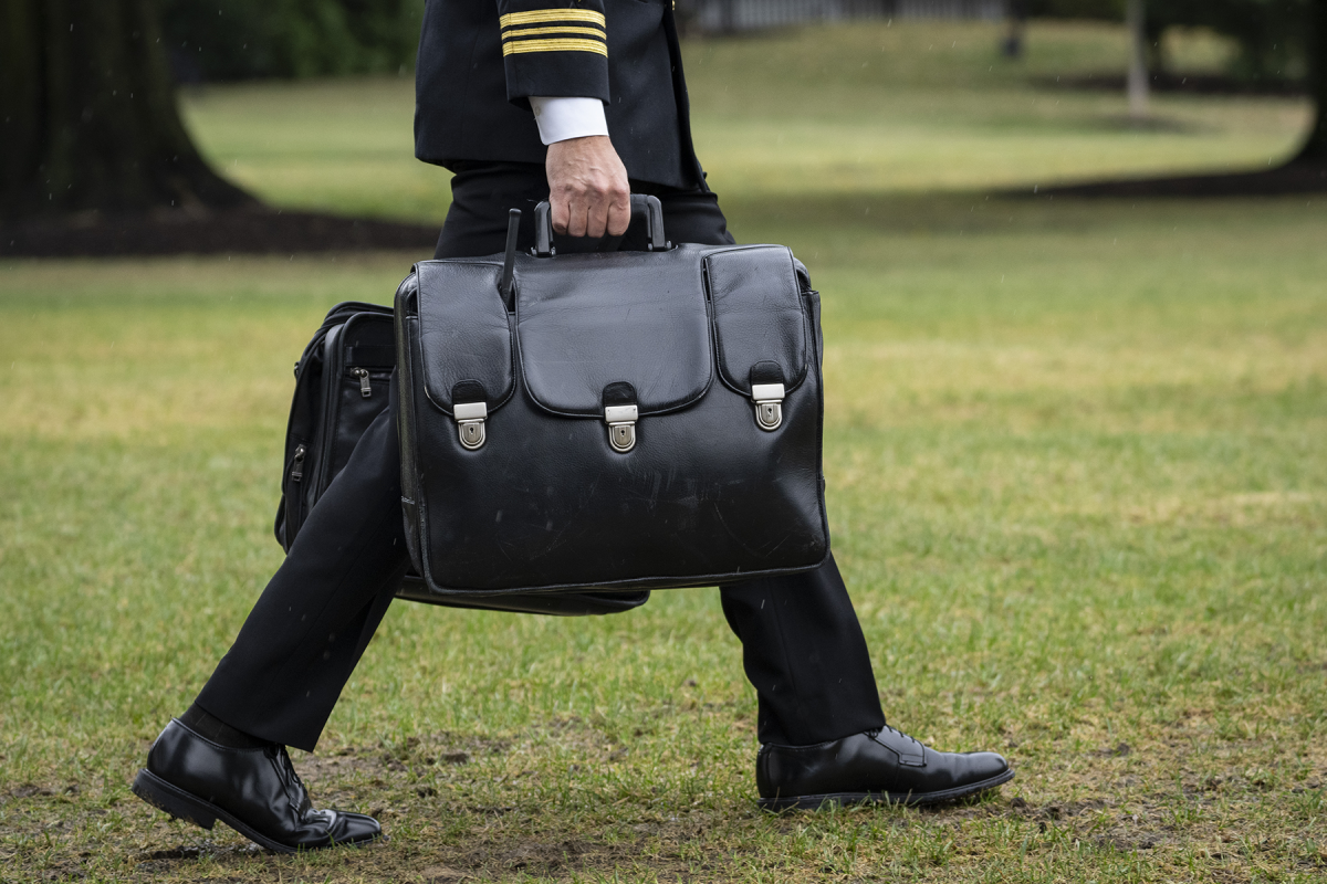 A military aide carries the 