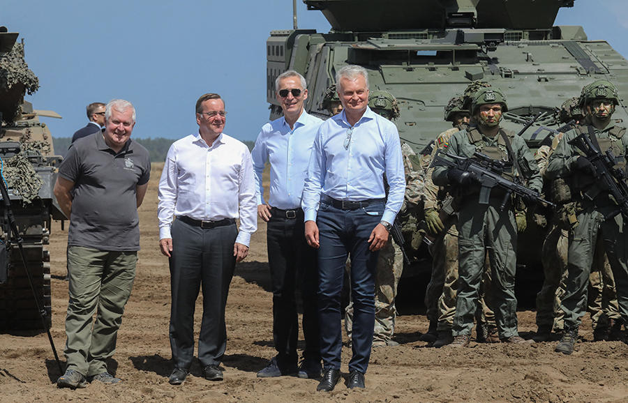 Lithuanian Defense Minister Arvidas Anusauskas (L to R), German Defense Minister Boris Pistorius, NATO Secretary-General Jens Stoltenberg, and Lithuanian President Gitanas Nauseda visit soldiers taking part in a Lithuanian-German military exercise in Lithuania, on June 26. Germany says it will station 4,000 troops in Lithuania, which asked NATO to strengthen its eastern flank. (Photo by Petras Malukas/AFP via Getty Images)