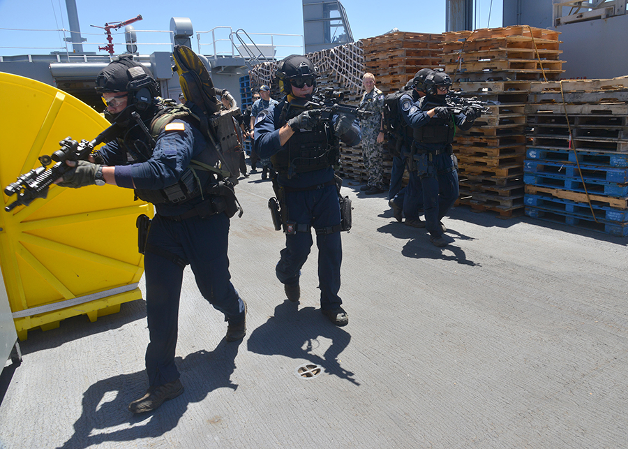 A U.S. Coast Guard team clears the main deck of USNS Henry J. Kaiser during a live training exercise at sea in the Indo-Pacific region in 2014. The exercise is designed to build regional capacity to counter the spread of weapons of mass destruction under the Proliferation Security Initiative.  (U.S. Navy photo by Mass Communication Specialist 1st class Amanda Dunford)