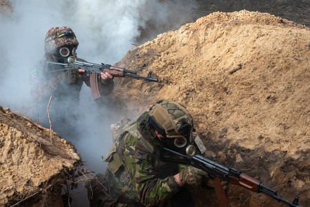 Members of the National Guard of Ukraine undergo training to storm enemy trenches using simulation equipment in February as the war between Russia and Ukraine continues in Kharkiv Region of Ukraine. (Photo by Stringer/Anadolu via Getty Images)
