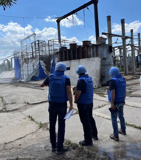 A team of experts with the International Atomic Energy Agency (IAEA) on June 20 assesses the damage at an electrical sub-station in the city of Enerhodar, home to many staff of the nearby Russian-occupied Zaporizhzhia Nuclear Power Plant in Ukraine. (Photo by IAEA)