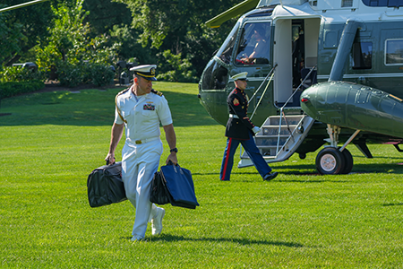 A presidential military aide, disembarking from Marine One, carries the nuclear football, which contains the necessary materials for the U.S. president to launch a nuclear strike. (Photo by Andrew Leyden/NurPhoto via Getty Images)