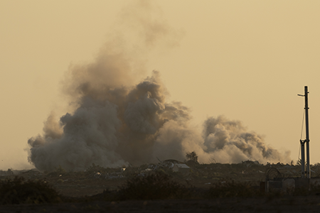 Smoke rises over the Gaza Strip after an Israeli bombardment on July 23. Hamas attacked Israel on Oct. 7, 2023, prompting Israel’s invasion of Gaza.  (Photo by Amir Levy/Getty Images)