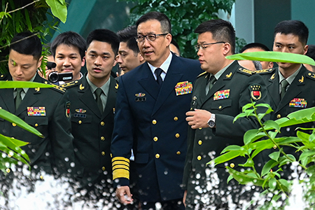 Chinese Defense Minister Dong Jun (C) arrives with his delegation for a bilateral meeting with U.S. Secretary of Defense Lloyd Austin on the sidelines of the Shangri-La Dialogue meeting in Singapore on May 31. It was a rare occasion on which the defense chiefs held direct talks. (Photo by Roslan Rahman/AFP via Getty Images)