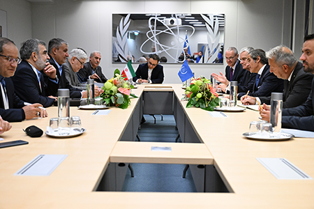 Rafael Mariano Grossi (Right, Center), director-general of the International Atomic Energy Agency, meets Mohammad Eslami (Center, Left), head of the Atomic Energy Organization of Iran, at IAEA headquarters in Vienna in September. Grossi is pressing Iran to allow the resumption of more rigorous monitoring of its nuclear program.  (Photo by Dean Calma / IAEA)