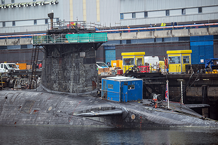 A UK Vanguard-class submarine undergoes maintenance at HM Naval Base Clyde near Glasgow in 2023. The program is in poor shape and there are questions about whether the planned submarine replacement program will meet its deadline. (Photo by Andy Buchanan/AFP via Getty Images)