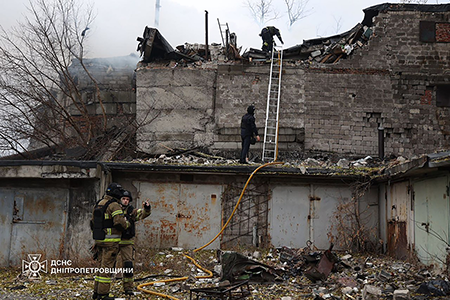 Firefighters work at the site of a Russian missile strike in Dnipro, Ukraine on Nov. 21. The strike occurred two days after Ukraine for the first time used U.S.-supplied short-range ballistic missiles to strike Russia. (Photo by Press Service of the State Emergency Service of Ukraine in Dnipropetrovsk Region / Handout/Anadolu via Getty Images)