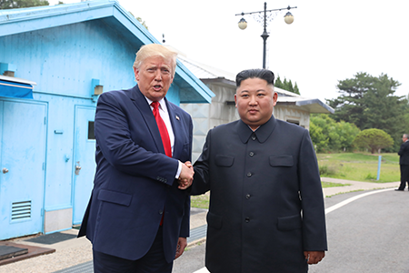 U.S. President Donald Trump (L) met North Korean leader Kim Jong Un at the demilitarized zone between North and South Korea in June 2019. Trump, newly returned to office, said in March that the United States is communicating with North Korea but did not provide details regarding his administration’s approach to addressing Pyongyang’s nuclear threat. (Handout photo by Dong-A Ilbo via Getty Images)