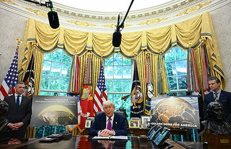 U.S. President Donald Trump speaks as U.S. Secretary of Defense Pete Hegseth (R) looks on during an announcement about the Golden Dome missile defense shield, in the Oval Office of the White House on May 20, 2025, in Washington, D.C. (Photo by Jim Watson/AFP via Getty Images)
