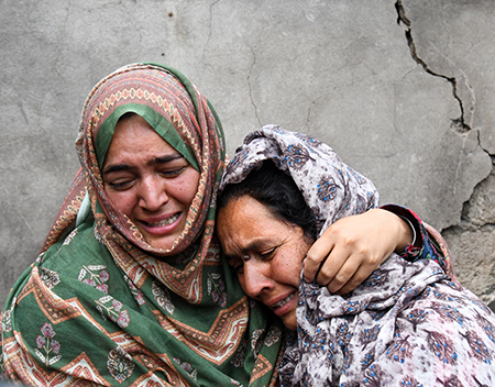 Women grieve after their home was destroyed May 8 following cross-border shelling between Pakistani and Indian forces near the Line of Control in disputed Kashmir. (Photo by Basit Zargar/Middle east images/AFP via Getty Images)