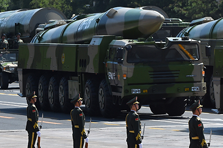 China is investing heavily in “information-age capabilities” such as these DF-26 conventional precision ballistic missiles. (Photo by Greg Baker/AFP via Getty Images)
