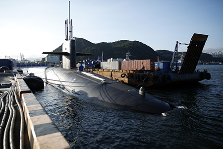 Adversary integration of AI-enhanced systems that can reliably locate submerged ballistic missile submarines could erode confidence in a state’s assured retaliation posture, writes Lt. Gen. John N.T. Shanahan. Here, the U.S. ballistic missile submarine USS Kentucky is anchored at Busan Naval Base in South Korea in 2023. (Photo by Woohae Cho/POOL/AFP via Getty Images)