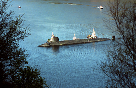 The final Trident nuclear submarine, HMS Vengeance, is escorted by tugboats into the naval base at Coulport, Scotland. The Royal Navy released radioactive water into Loch Long near Glasgow, due to its repeated failure to maintain a network of 1,500 water pipes at the Coulport armaments depot, home base for the United Kingdom’s nuclear warheads. (Photo by Ben Curtis/PA Images via Getty Images)