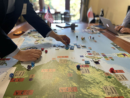 Participants in a wargame at the Massachusetts Institute of Technology contemplate their next move. (Photo courtesy of MIT Wargaming Lab)