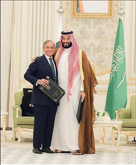 Pakistani Prime Minister Shebaz Sharif (L) and Saudi Crown Prince Muhammad bin Salman pose for photos Sept. 17 after signing a strategic mutual defense agreement that includes Pakistan's promise to defend Saudi Arabia with its nuclear deterrent. (Photo by Pakistan Information Department)