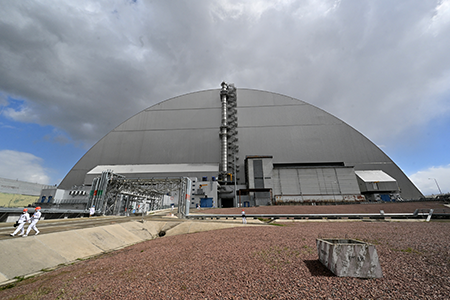 The United States announced it would contribute funds to repair damage done to the Chernobyl nuclear power plant. The repairs are necessary after the International Atomic Energy Agency assessed that the New Safe Confinement structure, built over the reactor after it melted down in 1986, sustained damage during a February 2025 drone strike. (Photo by Sergei Supinsky/AFP via Getty Images)