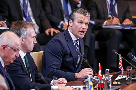 U.S. Secretary of Defense Pete Hegseth (R) addresses NATO defense ministers’ June 18 at alliance headquarters in Brussels, where he announced that Washington will conduct a six-month review of U.S. basing and force posture in Europe. (Photo by Omar Havana/Getty Images)